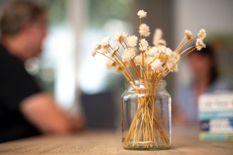 Wide Asleep Sleep Coaching Session, blurred participants with dried flowers in foreground